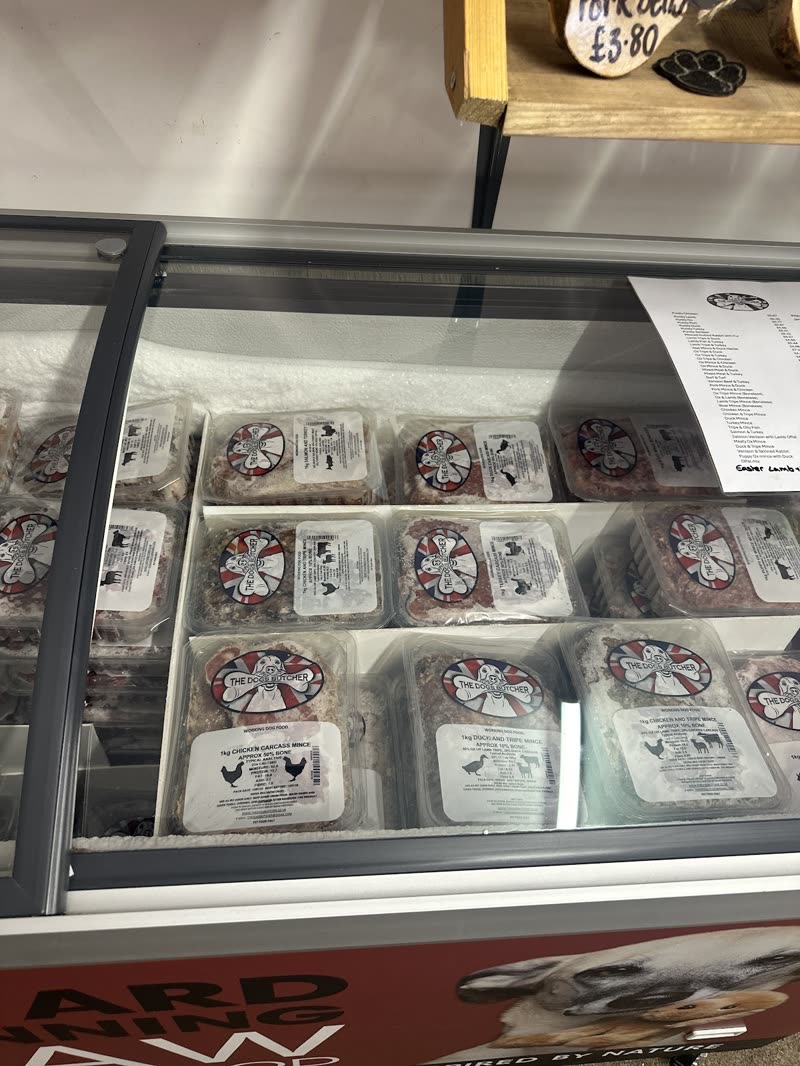 The chilled counter stocked with trays of raw dog food